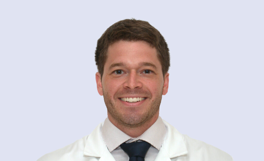 Newark and WIlmington, DE orthodontist Dr. Facciolo smiling in his white coat.