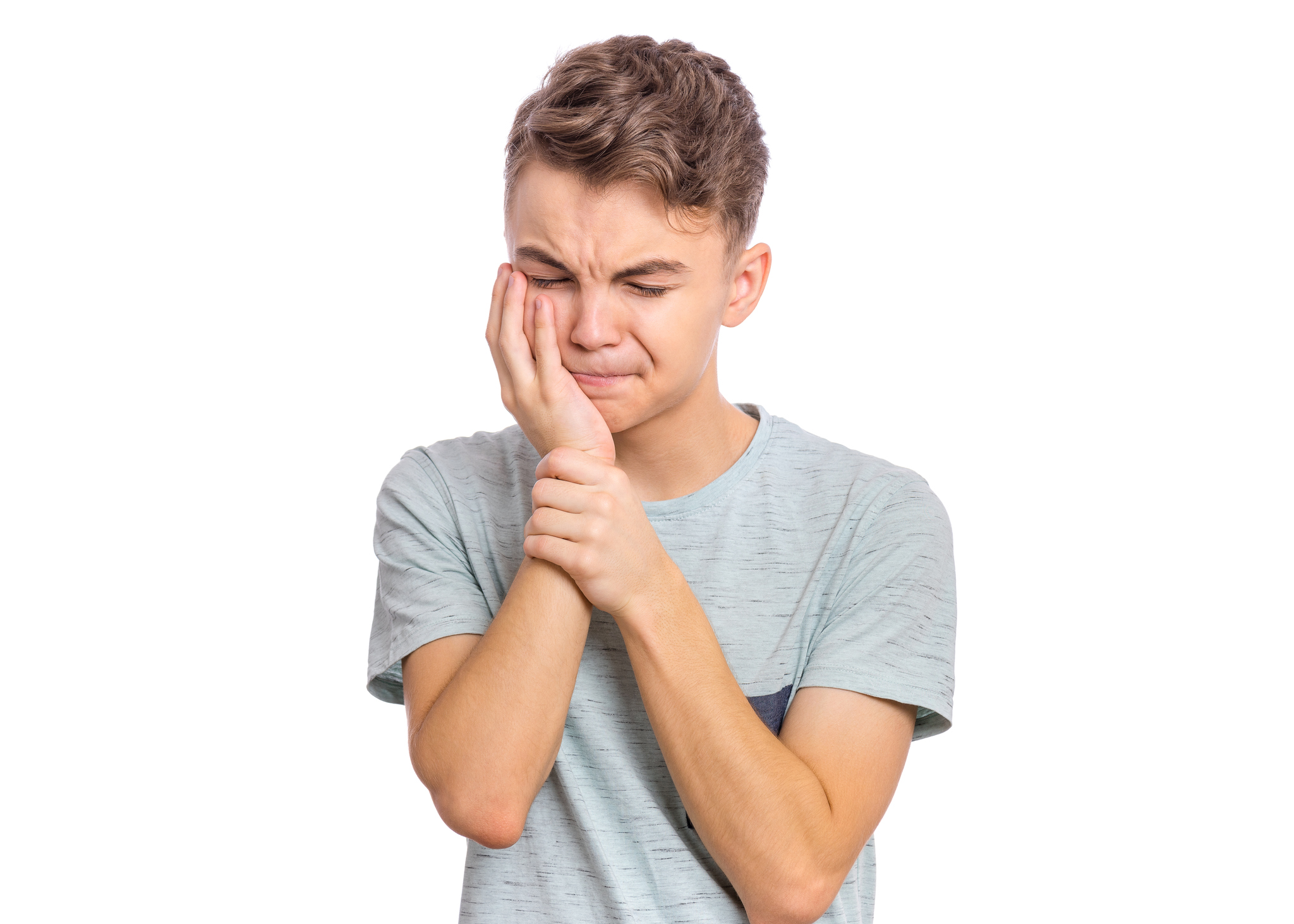 Handsome sad teen boy with tooth pain, isolated on white background